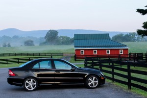 Used car in front of a red house